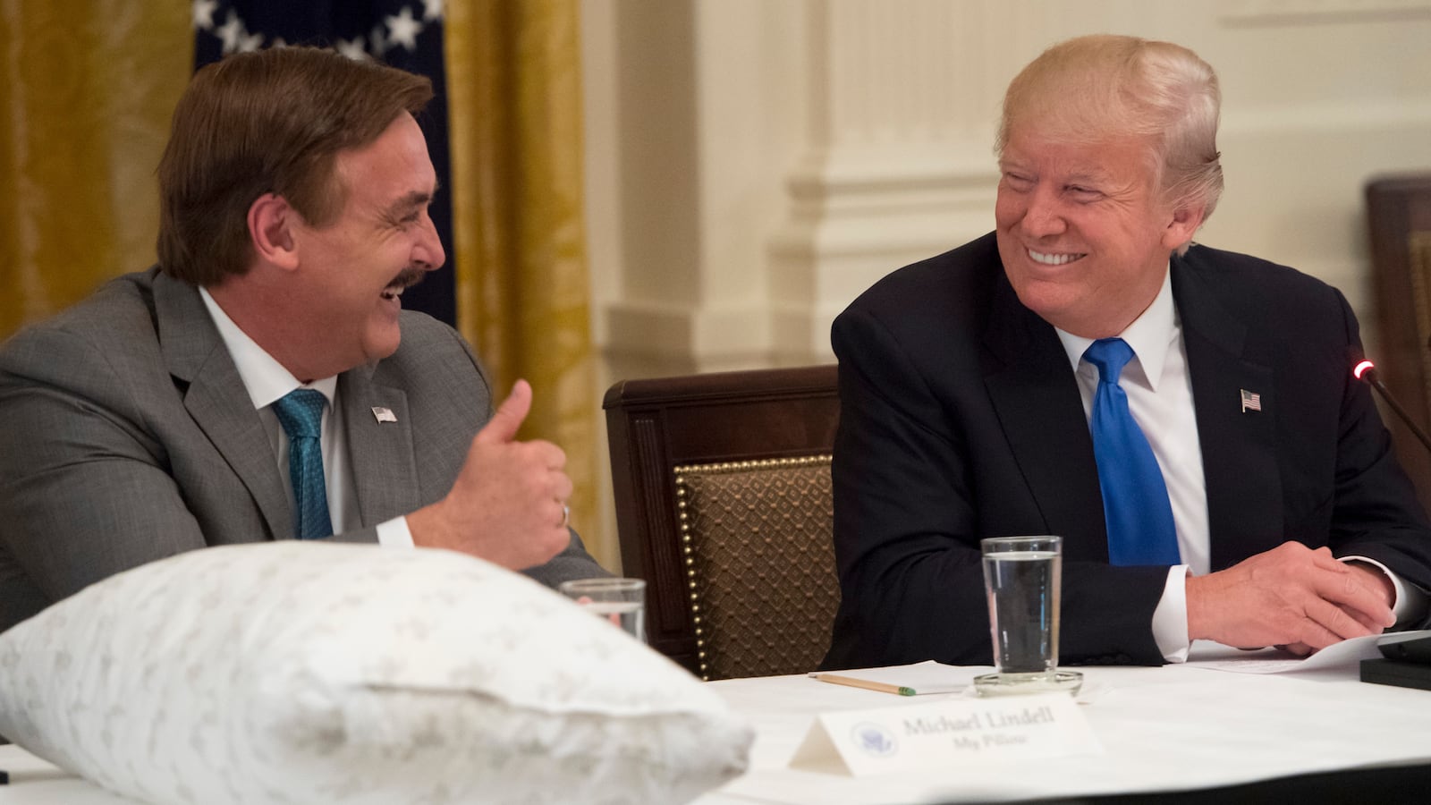 President Donald Trump speaks alongside Mike Lindell, founder of My Pillow. A White House official reportedly contacted the IRS about Lindell.