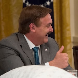 President Donald Trump speaks alongside Mike Lindell, founder of My Pillow. A White House official reportedly contacted the IRS about Lindell.