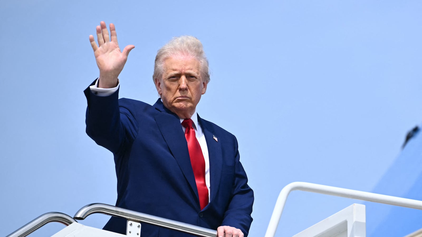 US President Donald Trump waves as he boards Air Force One at Joint Base Andrews in Maryland on April 3, 2025.